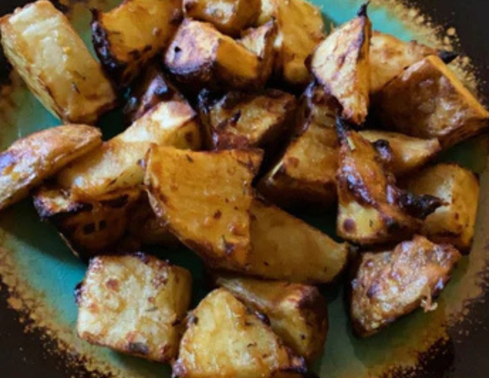Maple pecan roasted potatoes on a green plate
