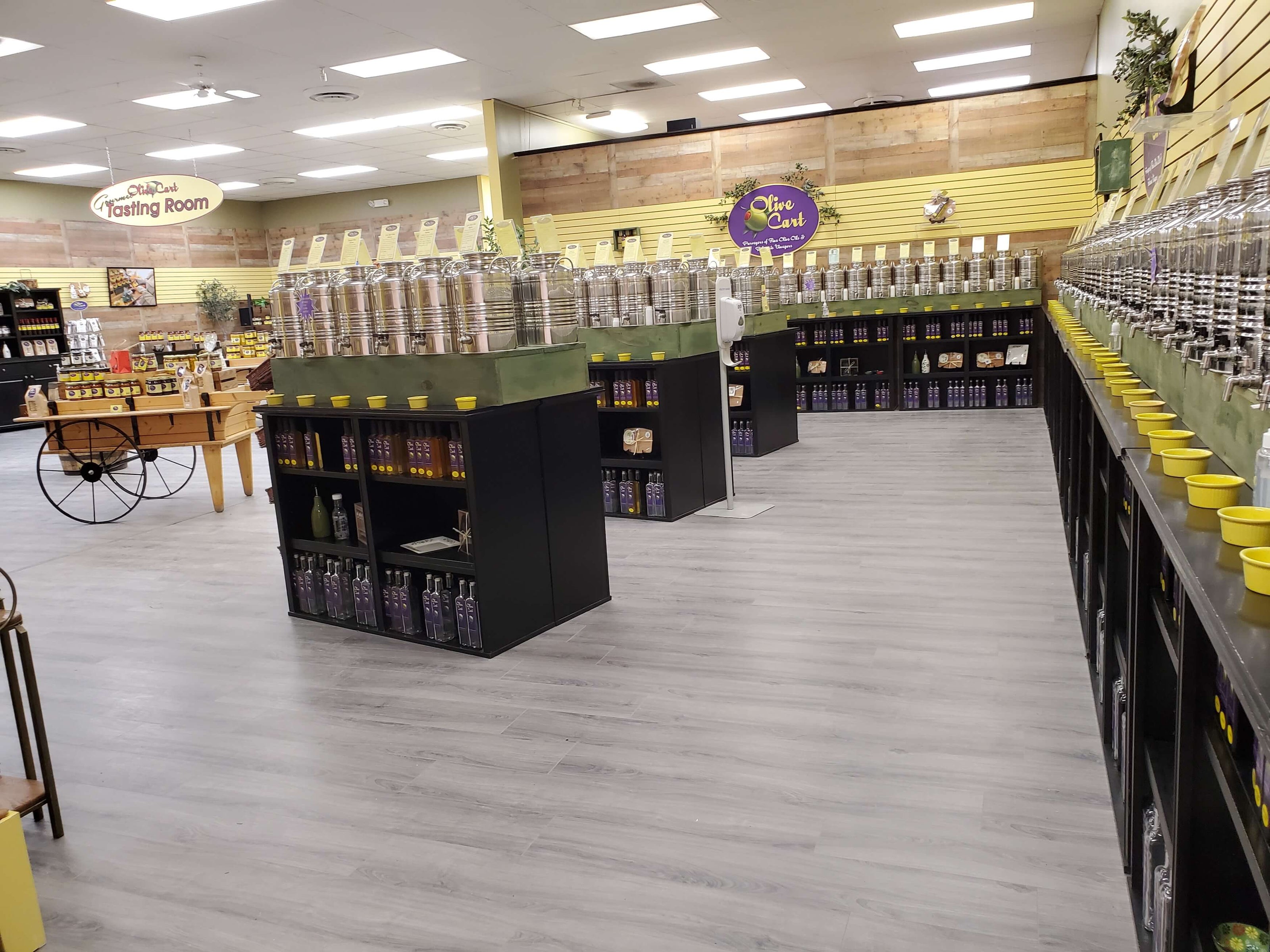 St. Joseph tasting room with shelves and bottles on a gray floor.